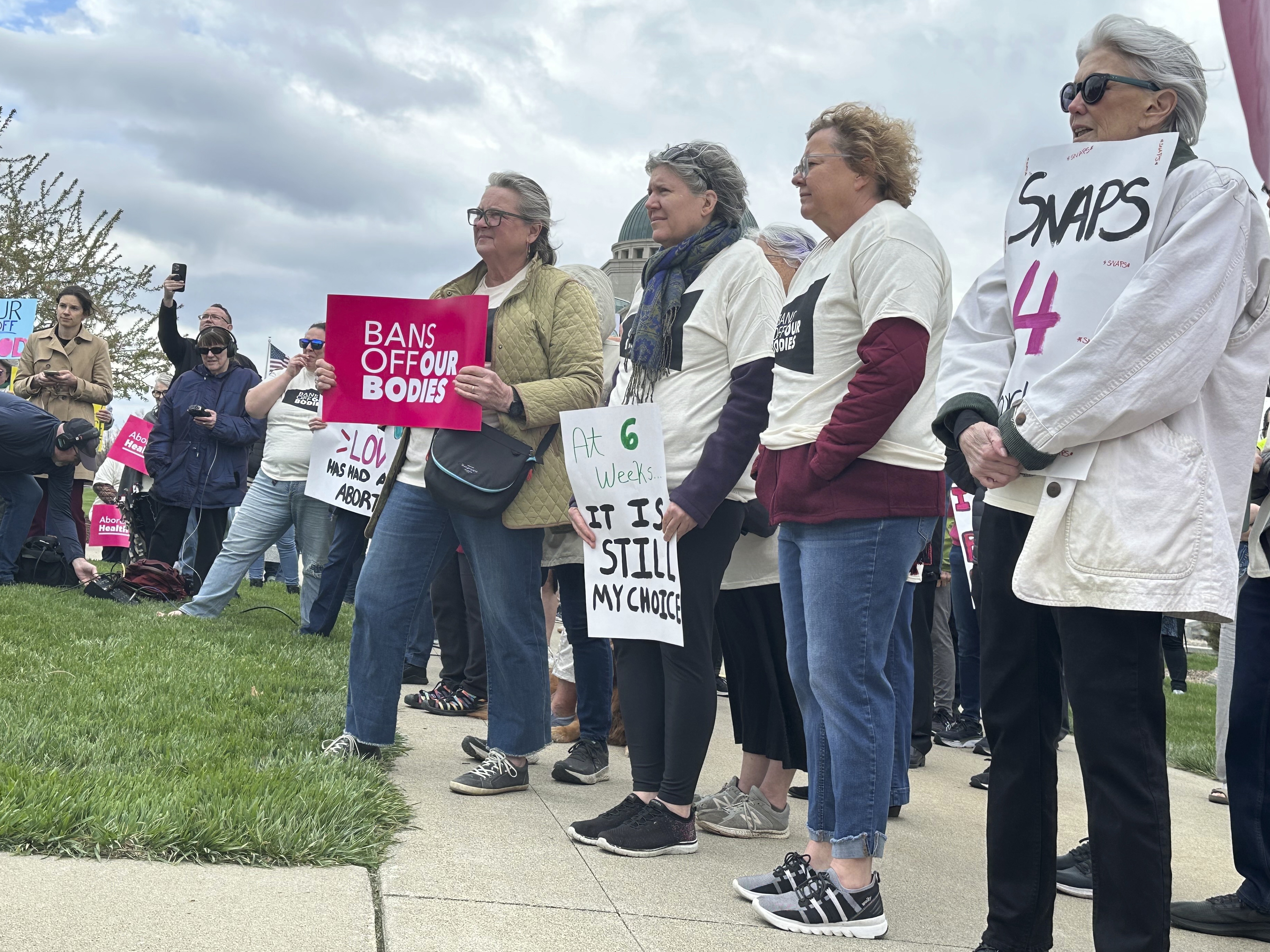 caption: Iowans supporting access to abortion rally on Thursday, April 11, 2024, outside the courthouse in Des Moines, Iowa, where the Iowa Supreme Court heard arguments on the state's restrictive abortion law. The law that bans most abortions after about six weeks of pregnancy. 