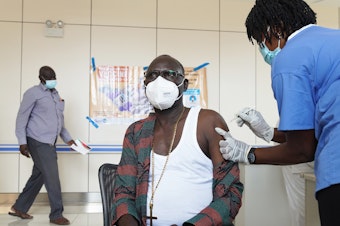 caption: A bishop receives a vaccine for COVID-19 at Juba Teaching Hospital on April 7 in Juba, South Sudan. South Sudan received 132,000 doses of the Oxford-AstraZeneca vaccine on March 25 through the World Health Organization's COVAX program to ensure all countries have equal access to vaccines.