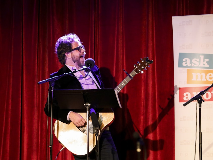 caption: <em>Ask Me Another</em>'s house musician Jonathan Coulton leads a music parody game at the Bell House in Brooklyn, New York.