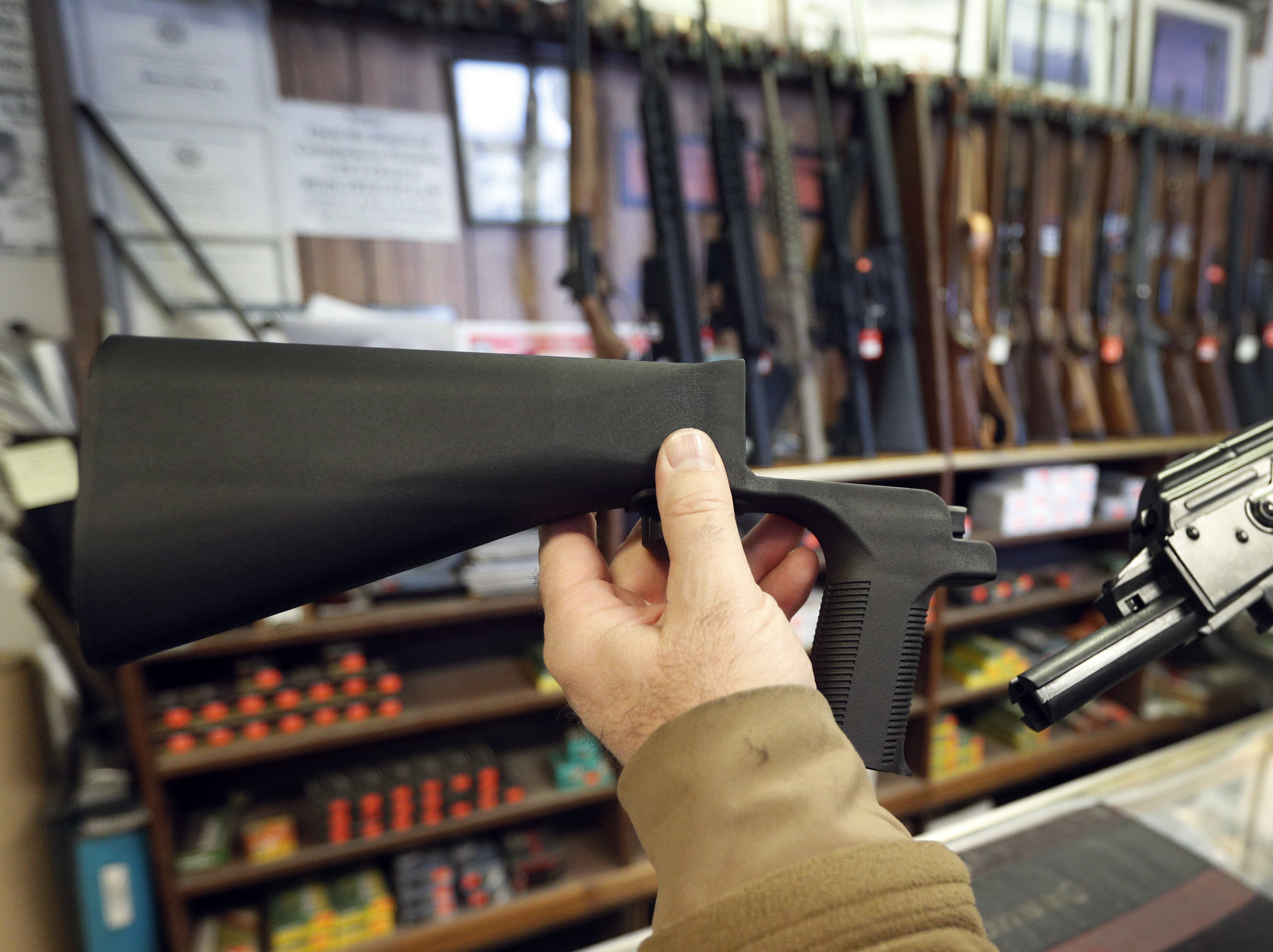 caption: A bump stock, left, is a device that can be added to a gun to increase its firing speed. The devices were banned by the federal government his week.