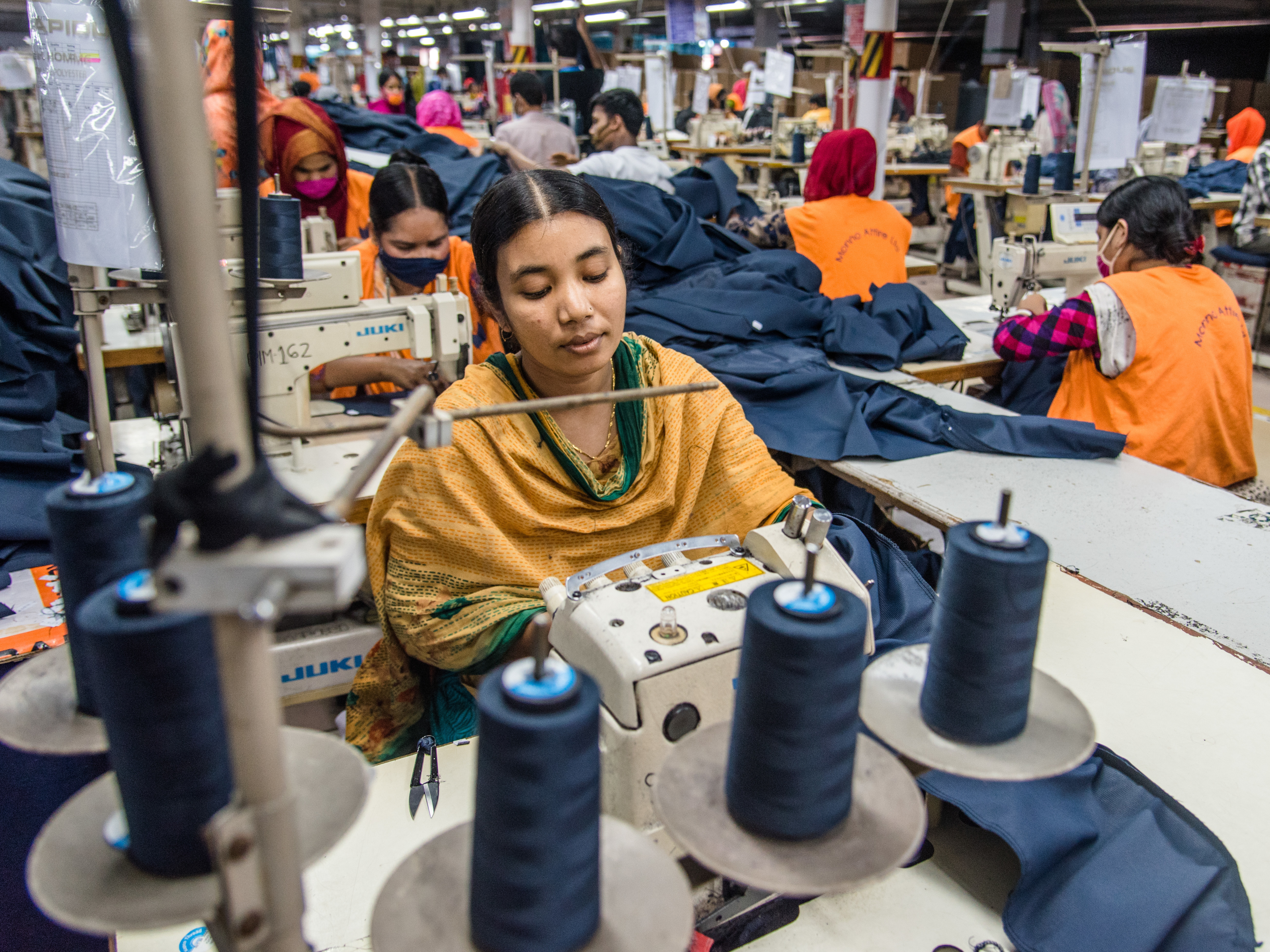 caption: Women manufacture clothes in Dhaka, Bangladesh on Aug. 29. The ready-made garment (RMG) industry in Bangladesh is now a mainstay of the country's economy. Today, Bangladesh is one of the world's largest garment exporters, with the sector accounting for more than 80% percent of Bangladesh's exports.