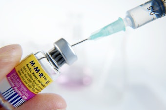 caption: MMR vaccine being drawn into a syringe. This combined vaccine protects children from three viral diseases: measles, mumps and rubella.