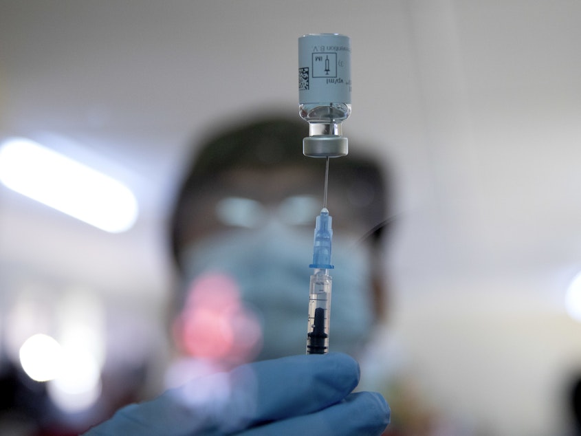 caption: A health care worker withdrew a dose of the Johnson & Johnson COVID-19 vaccine from a vial at the Klerksdorp Hospital in Klerksdorp, South Africa, on Feb. 18.