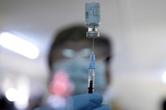 caption: A health care worker withdrew a dose of the Johnson & Johnson COVID-19 vaccine from a vial at the Klerksdorp Hospital in Klerksdorp, South Africa, on Feb. 18.