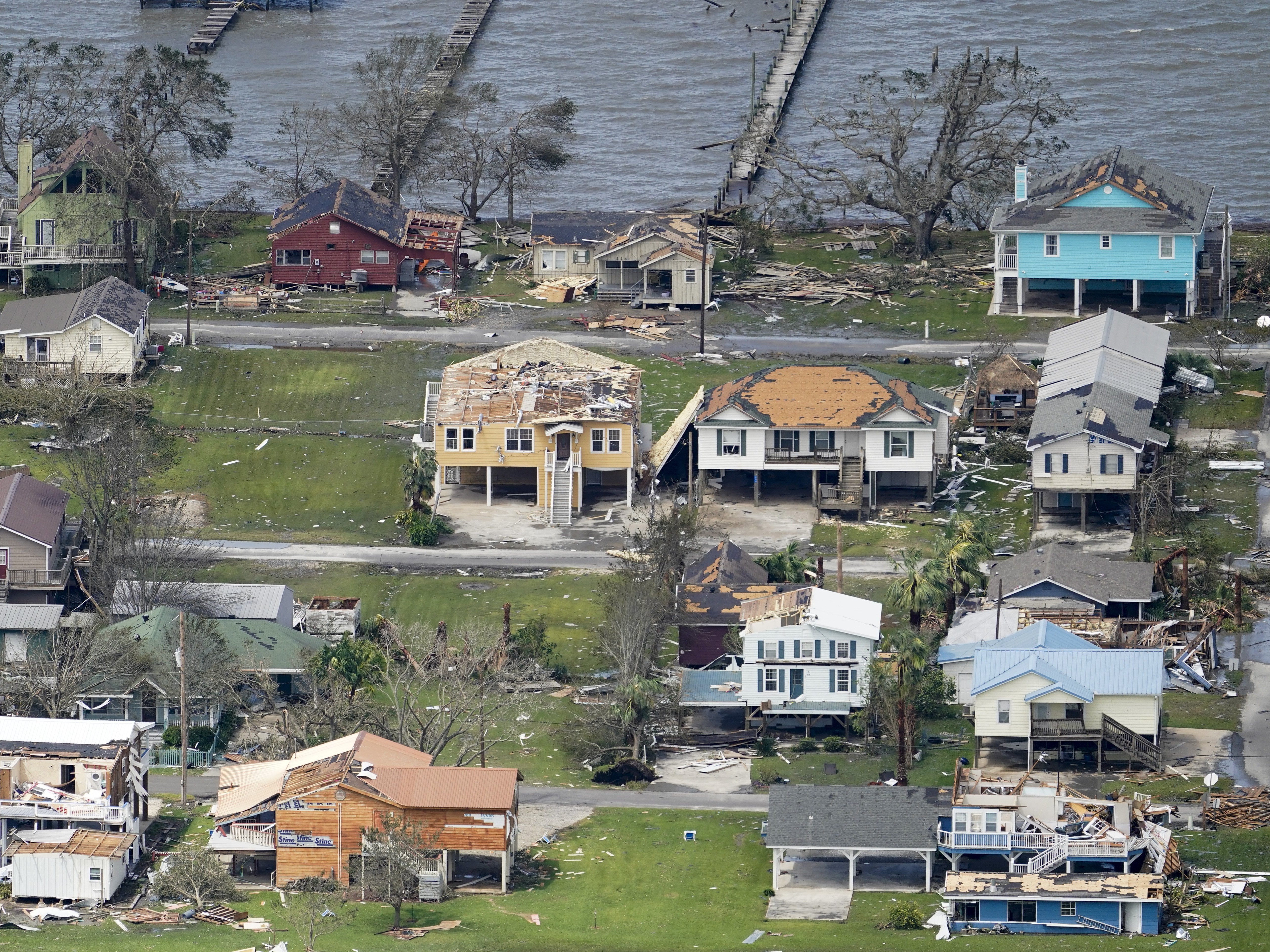 caption: Damaged buildings and homes are damaged in the aftermath of Hurricane Laura near Lake Charles, La., Thursday.
