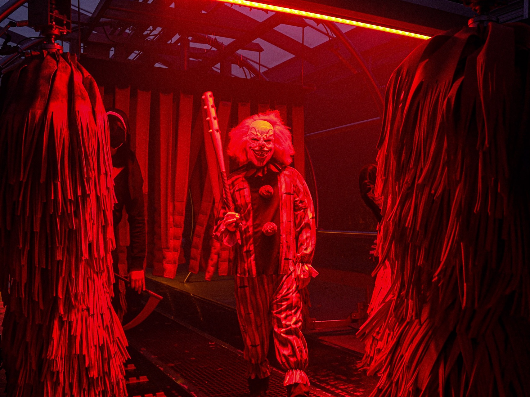 caption: A menacing clown lurks in a Tommy's Express car wash. For Halloween, the company runs 126 haunted car washes in 32 states.