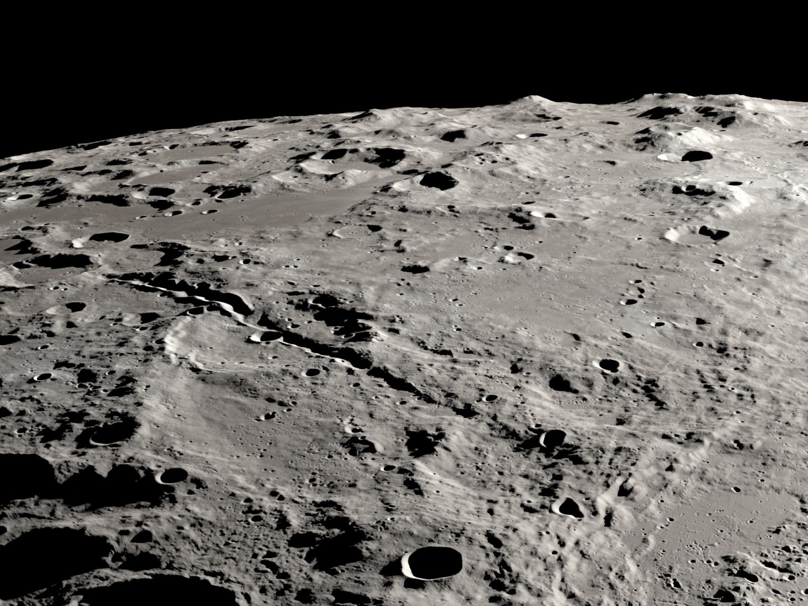 caption: Two grand canyons on the moon radiating from the Schrödinger impact basin, from a view that looks obliquely across the lunar surface, like an astronaut in an approaching spacecraft.