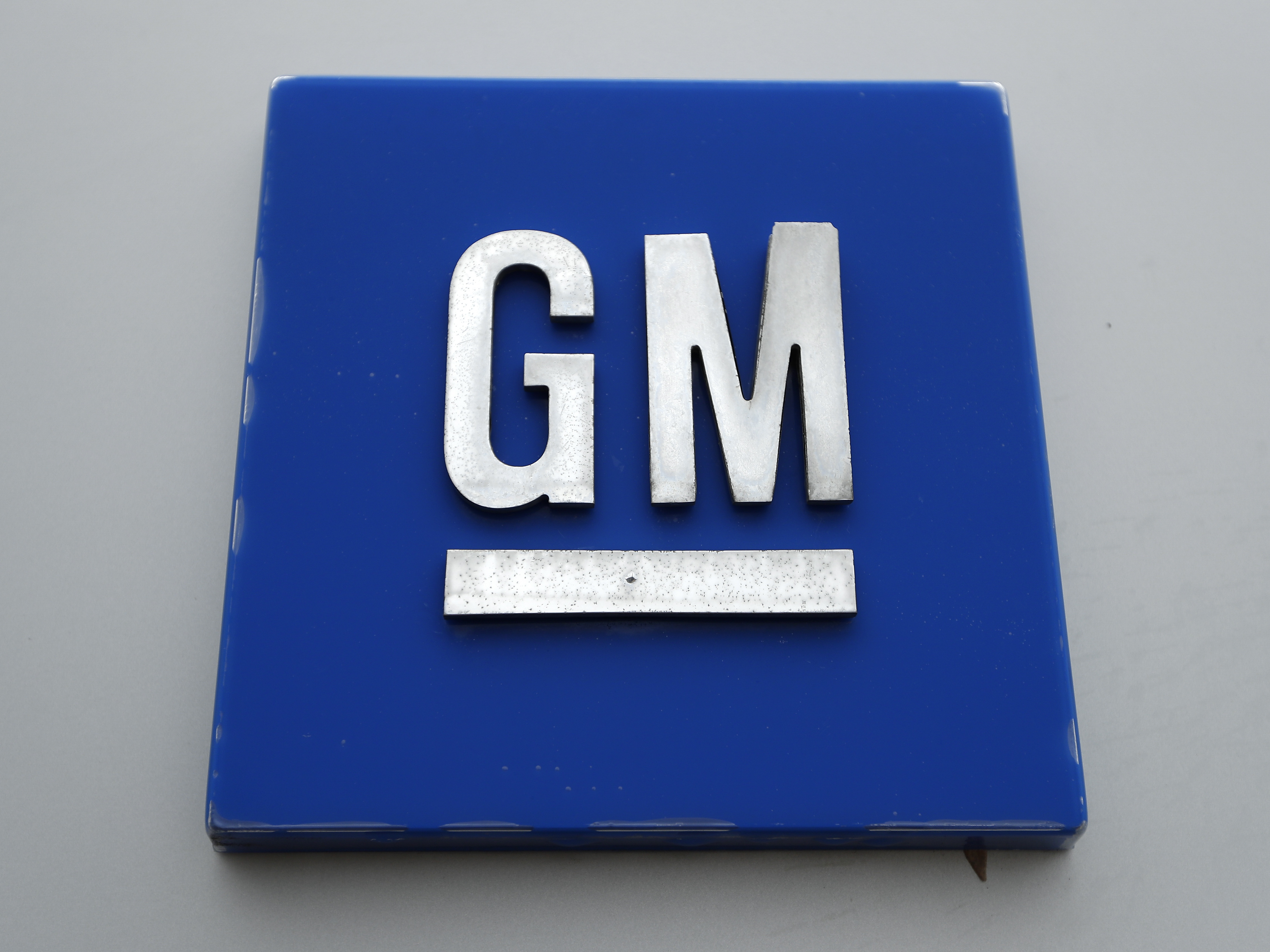 caption: A General Motors logo is seen at the General Motors Detroit-Hamtramck Assembly plant in Hamtramck, Mich. on Jan. 27, 2020.