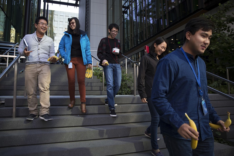 caption: From left, Amazon software development interns Min Vu, Cindy Wang, Jason Mar, Katie Shin and Louis Yang, walk after getting bananas from the Amazon Community Banana Stand outside of the Amazon Meeting Center on Thursday, October 5, 2017, in Seattle. 