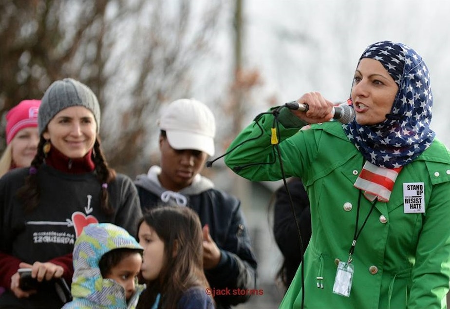 caption: Aneelah Afzali speaking at Womxn March Seattle in Judkins Park