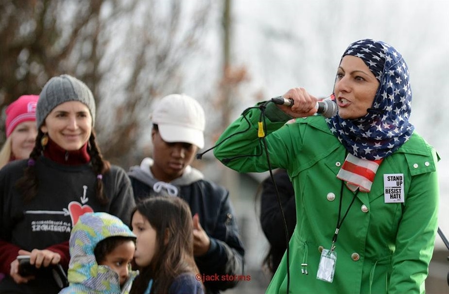 caption: Aneelah Afzali speaking at Womxn March Seattle in Judkins Park