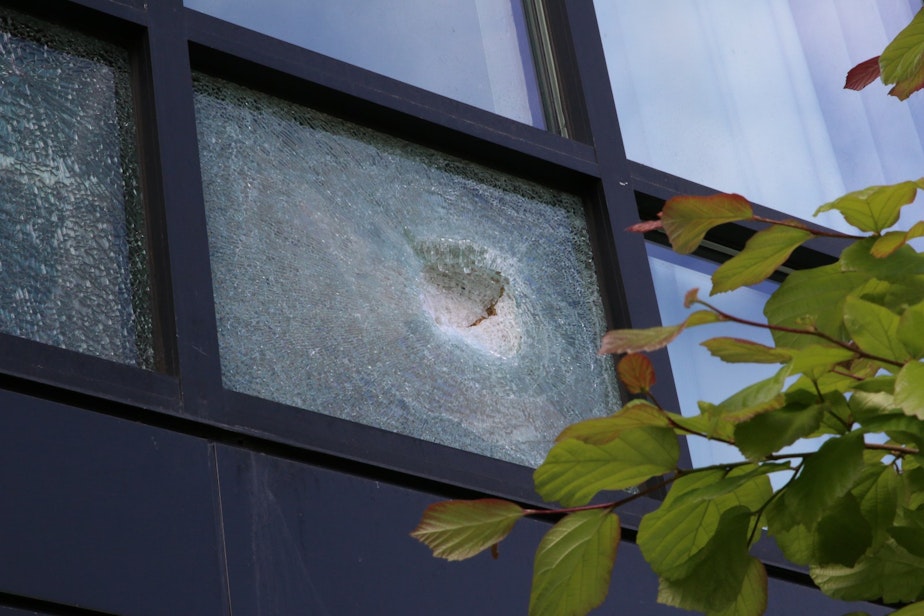 caption: Broken windows at the hotel across the street from where the crane collapsed.