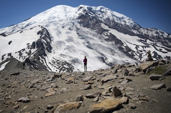 caption: Hikers stand along Burroughs Mountain Trail with a view of Mount Rainier on Saturday, July 20, 2019.