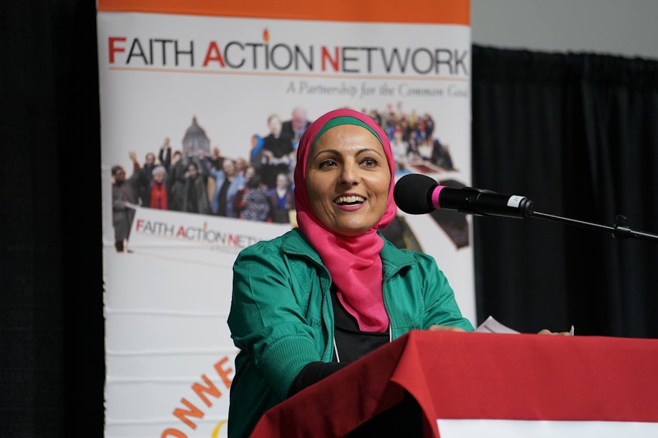 caption: Annelah Afzali speaks at an event for the Faith Action Network. 