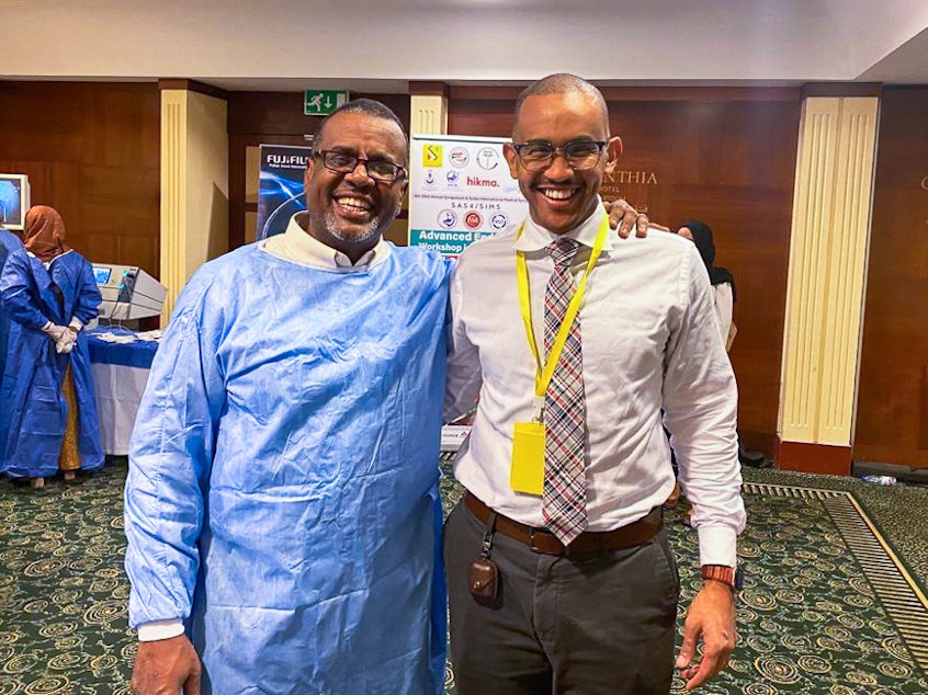 caption: Dr. Bushra Sulieman (left) and Dr. Mohamed Eisa in February 2023 at a workshop in Khartoum. Sulieman was killed on April 25 in Khartoum. It's believed he was stabbed to death during a robbery attempt amid the turmoil of the conflict that has broken out in Sudan.
