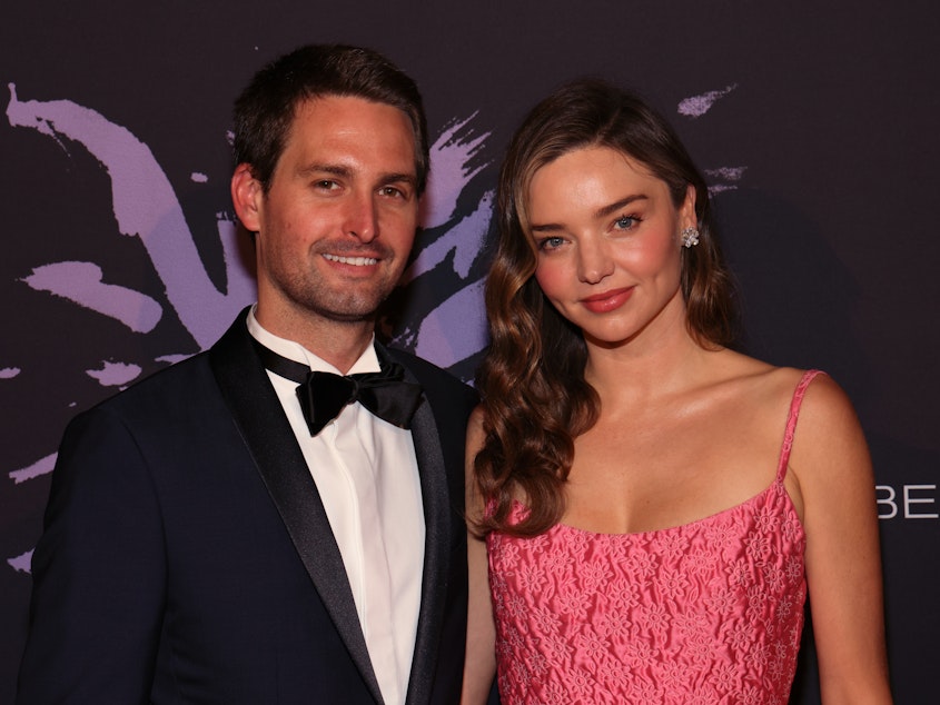 caption: Snap CEO Evan Spiegel and KORA Organics CEO Miranda Kerr attend a gala in Beverly Hills, Calif., on May 4. The couple surprised graduates of a Los Angeles art school by paying off their student debt.