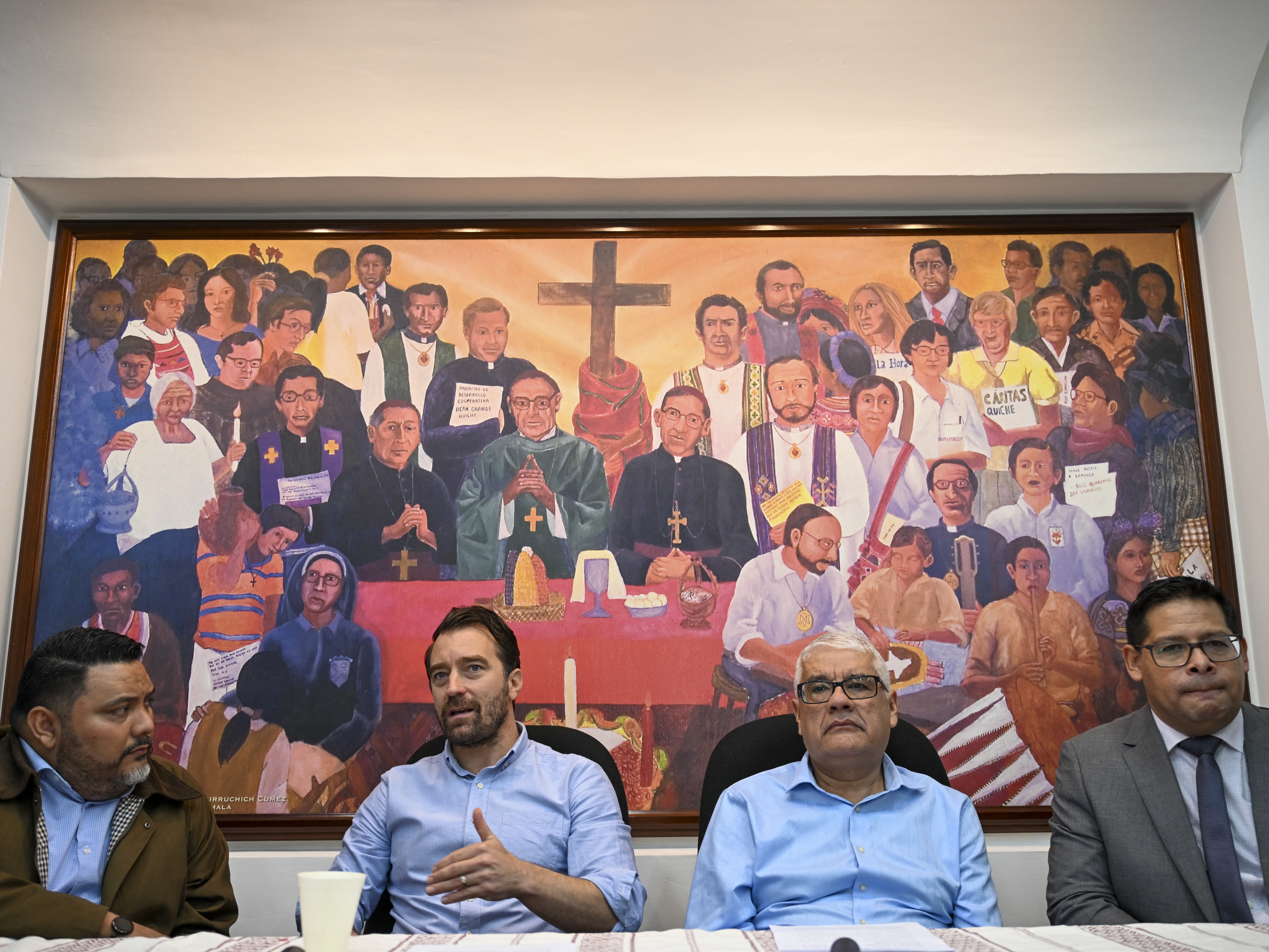 caption: Executive director of the NGO Cristosal, Noah Bullock (C) speaks next to director of research Rene Valiente (L), Abraham Abrego (2nd R), director of the strategic litigation and Guatemalan lawyer Rafael Cruz (R) during a press conference in Guatemala City on July 17, 2025.