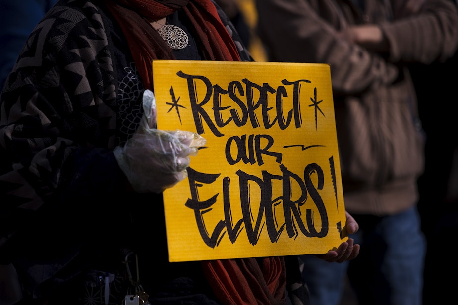 caption: A sign reading 'Respect Our Elders' is shown as hundreds gathered for the 'We Are Not Silent' rally against anti-Asian hate and violence on Saturday, March 13, 2021, at Hing Hay Park in Seattle. Several days of actions are planned by rally organizers in the Seattle area following recent attacks and violence against Asian American and Pacific Islander communities.