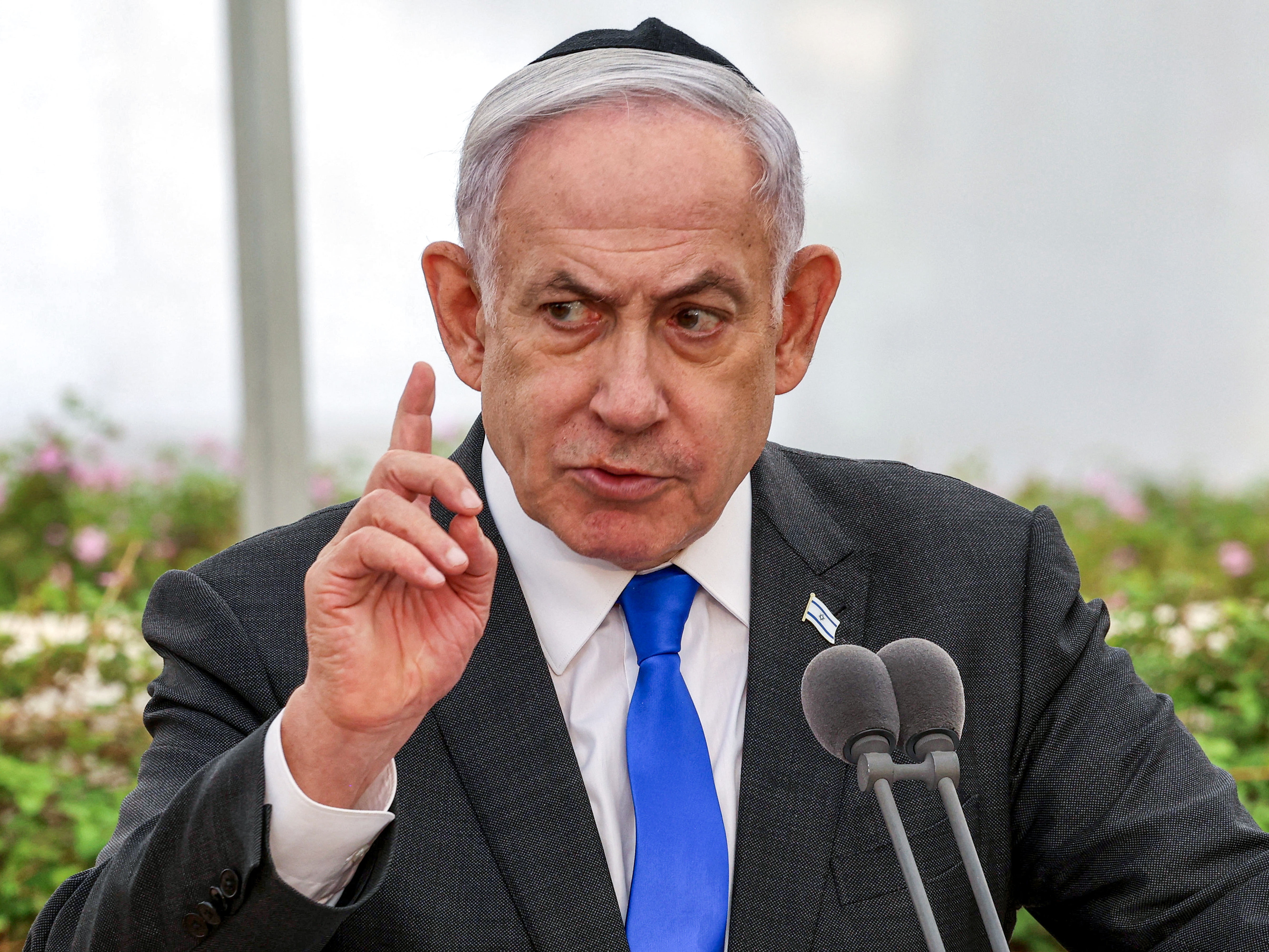 caption: Israeli Prime Minister Benjamin Netanyahu speaks during a memorial ceremony in Tel Aviv on June 18.