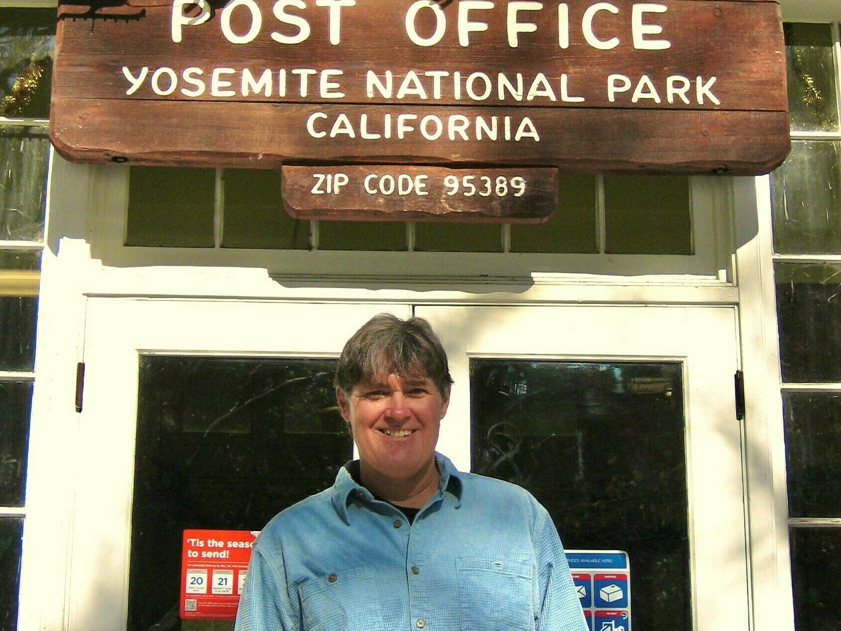 caption: John Reynolds outside of the Post Office on Christmas, a regular part of his job.