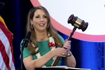 caption: Re-elected Republican National Committee Chair Ronna McDaniel holds a gavel while speaking at the committee's winter meeting in Dana Point, Calif., on Friday.
