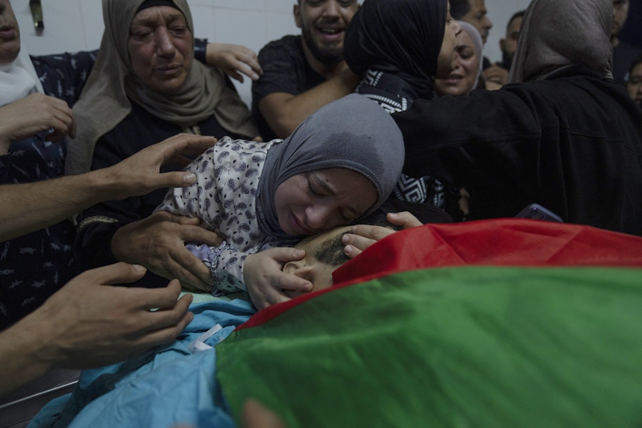 caption: Alaa Jadelhaq, wife of Mohanad Jadelhaq, 29 takes the last look at his body during his funeral in the West Bank city of Ramallah, Thursday, Nov. 9, 2023. Jadelhaq was killed during an Israeli army raid in the occupied West Bank refugee camp of Amari, Palestinian ministry of health said.