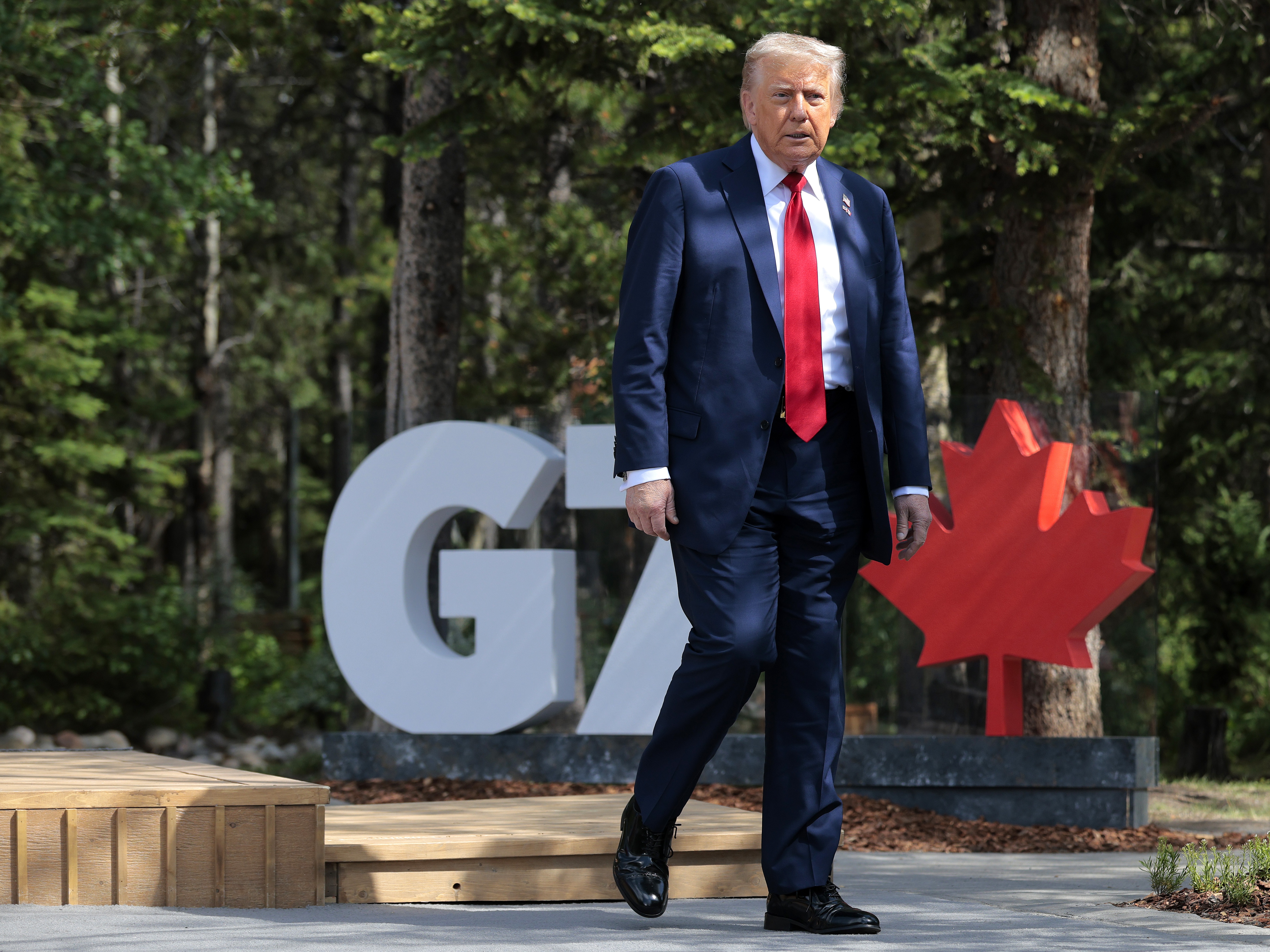 caption: President Trump arrives for the official welcome ceremony during the G7 Leaders' Summit on June 16 in Kananaskis, Alberta. Canada is hosting this year's meeting of the world's seven largest economies.