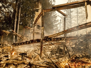 caption: Charred framing remains, Monday, Sept. 28, at the Restaurant at Meadowood, which burned in the Glass Fire, in St. Helena, Calif.
