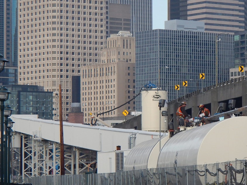 caption: Seattle Tunnel Partners workers atop a tank of soil conditioner used by tunnel builders 