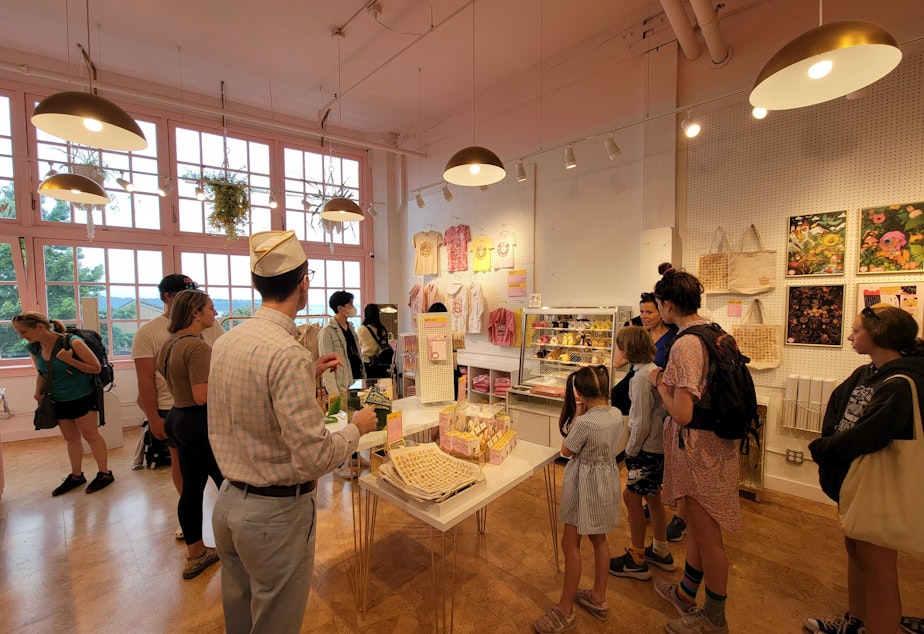 caption: Thomas Marnin, left, oversees customers in the Pike Place Market toy store he co-owns, MarninSaylor.