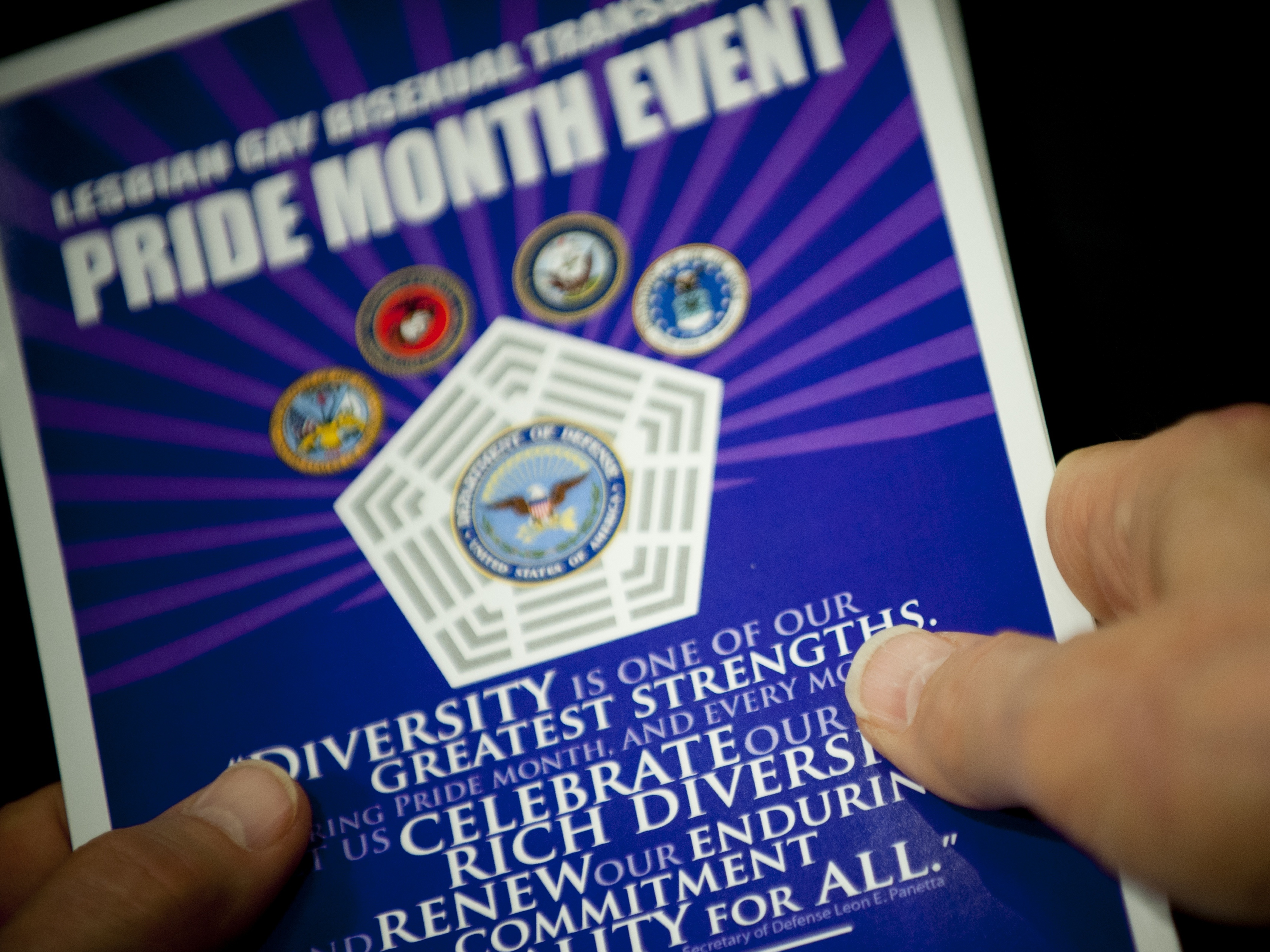 caption: Close up of hands holding a pamphlet at the Pentagon during a Lesbian, Gay, Bi-Sexual, and Transgender Pride Month event. DOD photo by U.S. Navy Petty Officer 1st Class Chad J. McNeeley. 2015.