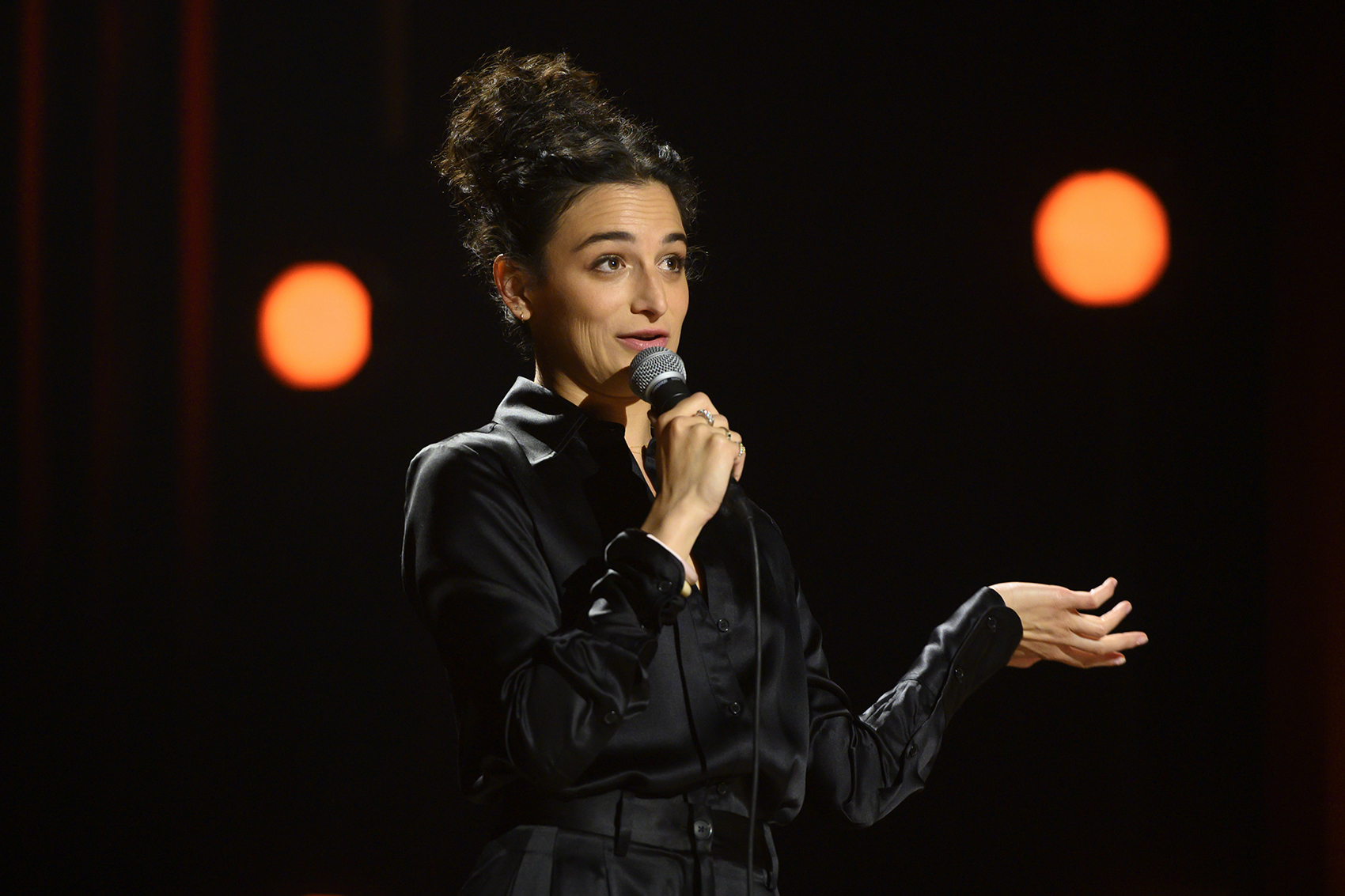 caption: Jenny Slate in her special "Stage Fright." (JoJo Whilden/Netflix)