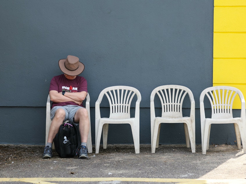 caption: A spectator sleeps during IRONMAN Ireland, Cork on August 14, 2022 in Cork, Ireland.