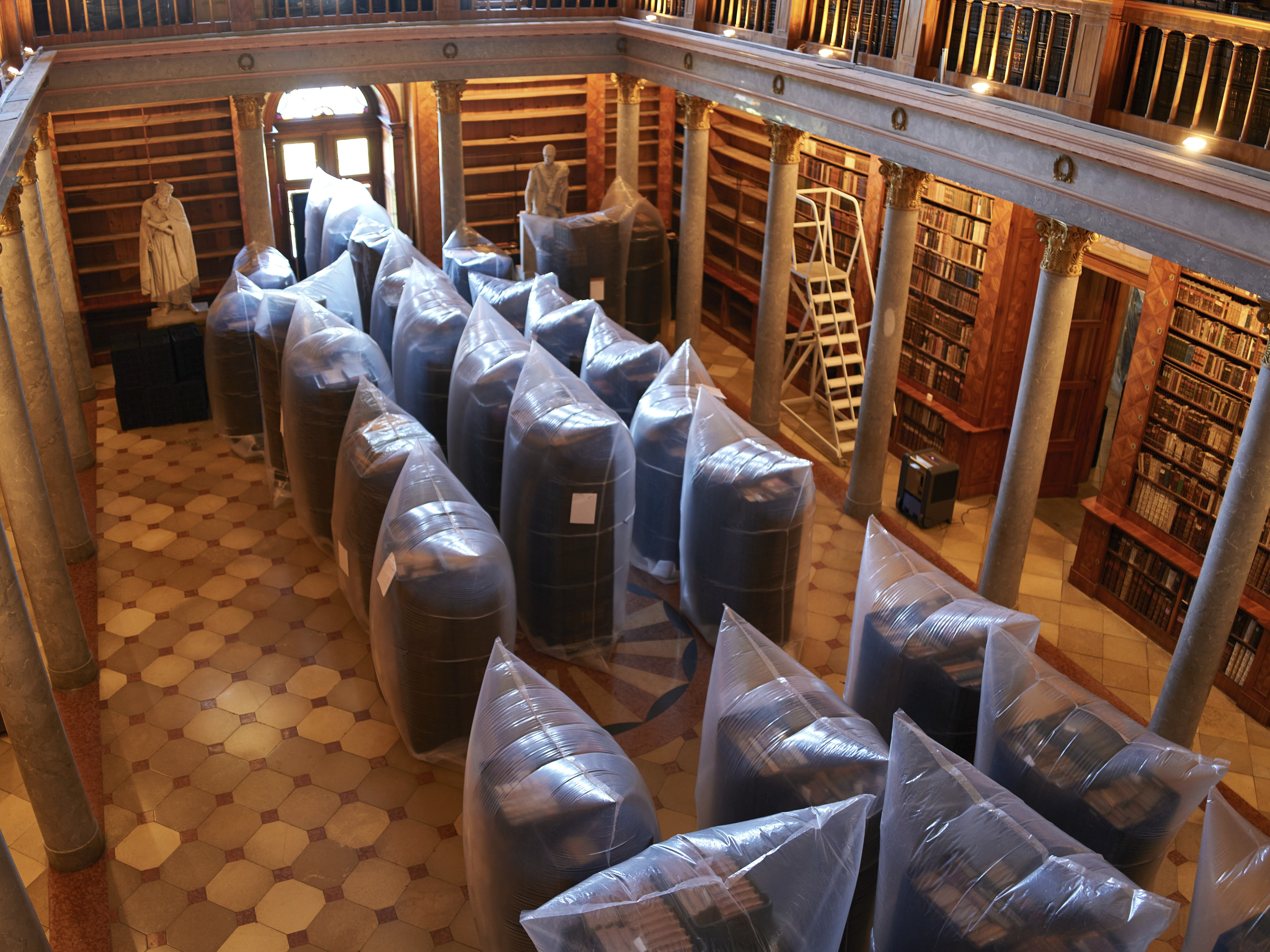 caption: Books are kept in hermetically sealed plastic sacks for disinfection, at the Pannonhalma Archabbey's library in Pannonhalma, Hungary on July 3.