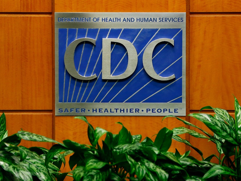 caption: A podium with the logo for the Centers for Disease Control and Prevention at the Tom Harkin Global Communications Center in Atlanta.