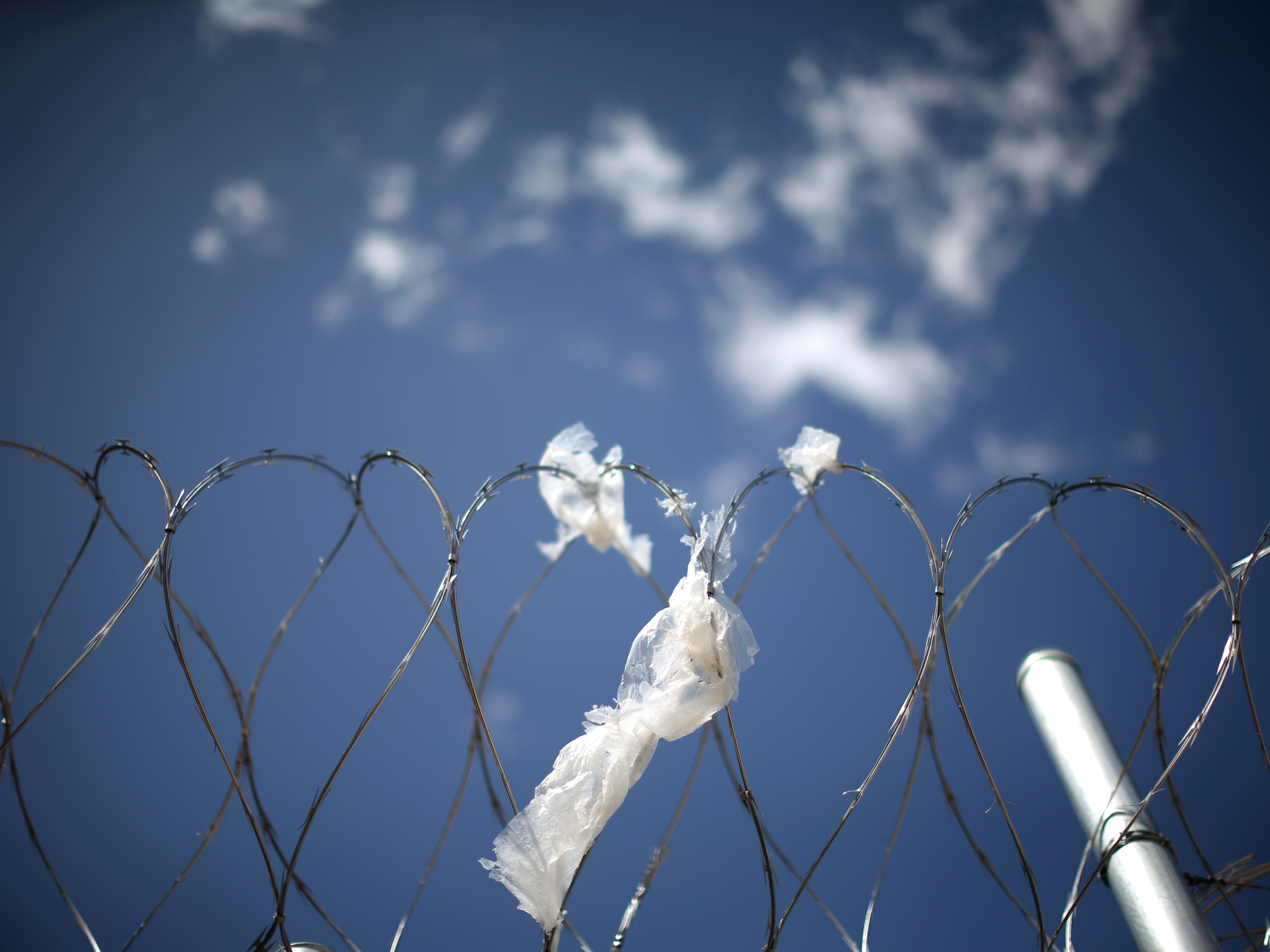 caption: A razor wire fence surrounds the Adelanto immigration detention center, in Adelanto, Calif., April 13, 2017.