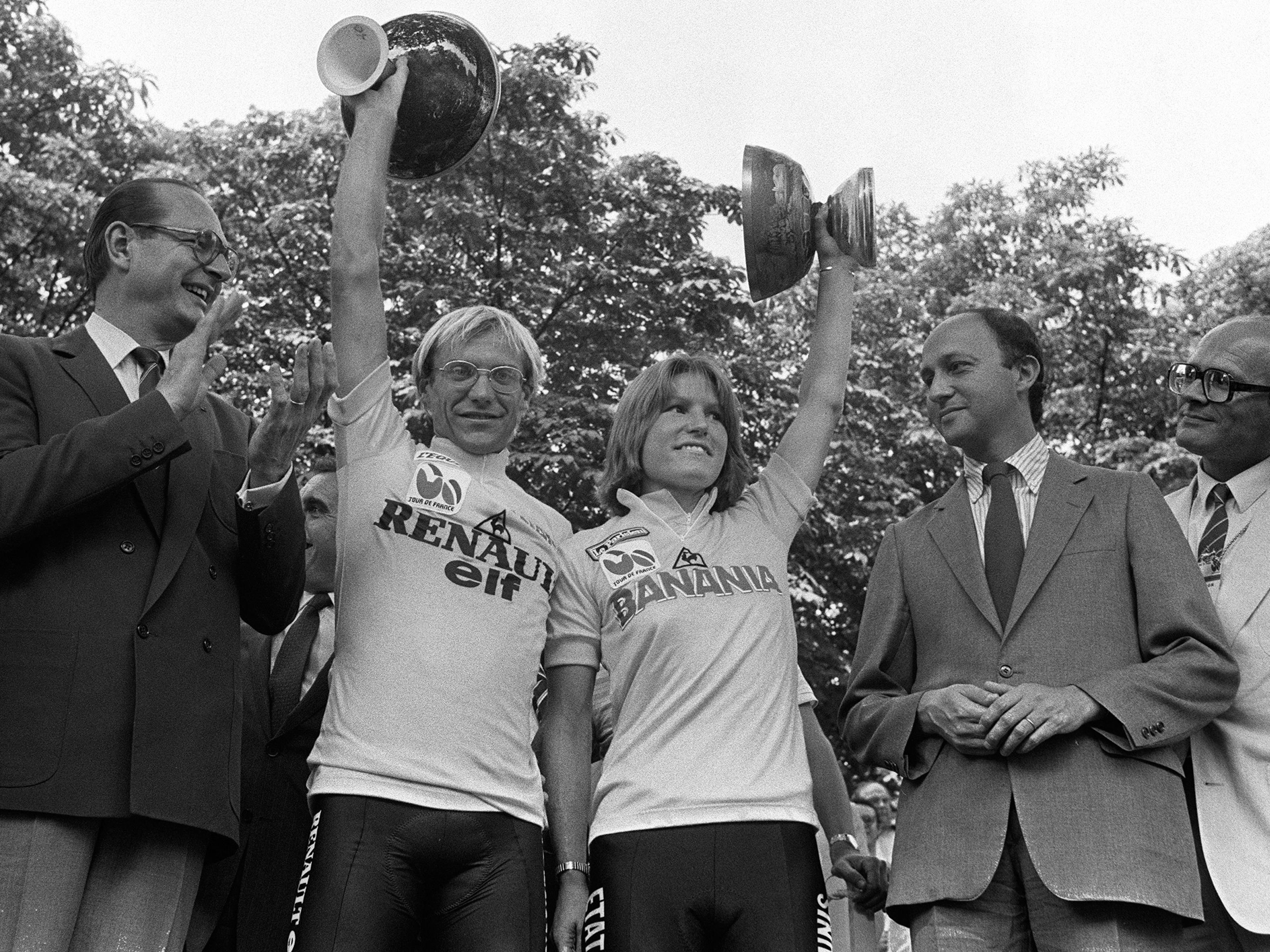 caption: Marianne Martin stands alongside fellow Tour de France winner Laurent Fignon on the podium in Paris on July 22, 1984. Martin received around $1,000 for her win; Fignon got more than $100,000.