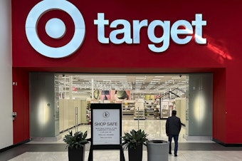 caption: A lone shopper heads into a Target store on Jan. 11 in Lakewood, Colo.