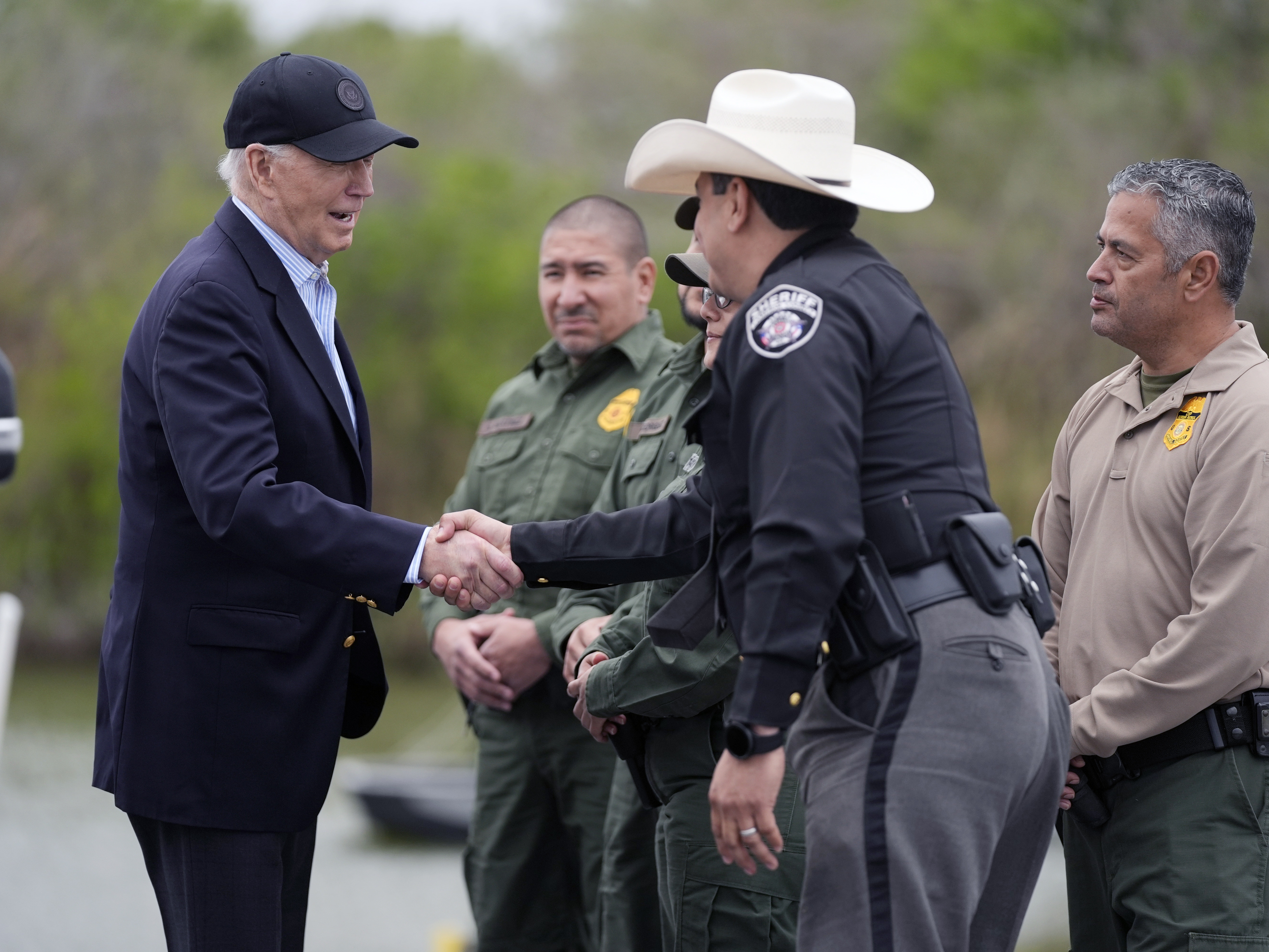 caption: President Joe Biden is shown speaking with the U.S. Border Patrol and local officials, as he looks over the southern border, Feb. 29, 2024, in Brownsville, Texas, along the Rio Grande.