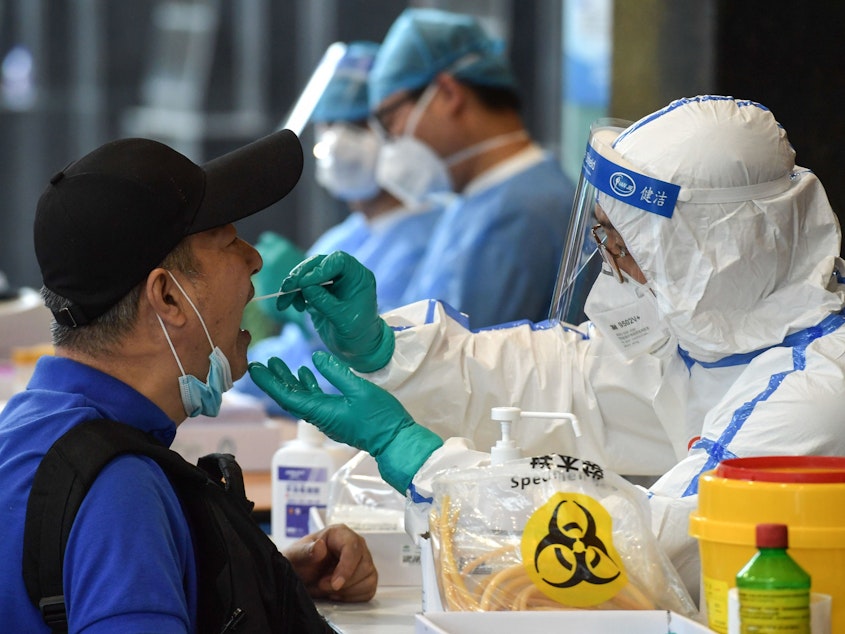 caption: A man who visited Beijing recently is tested for the coronavirus in Nanjing in China's eastern Jiangsu province on Monday.