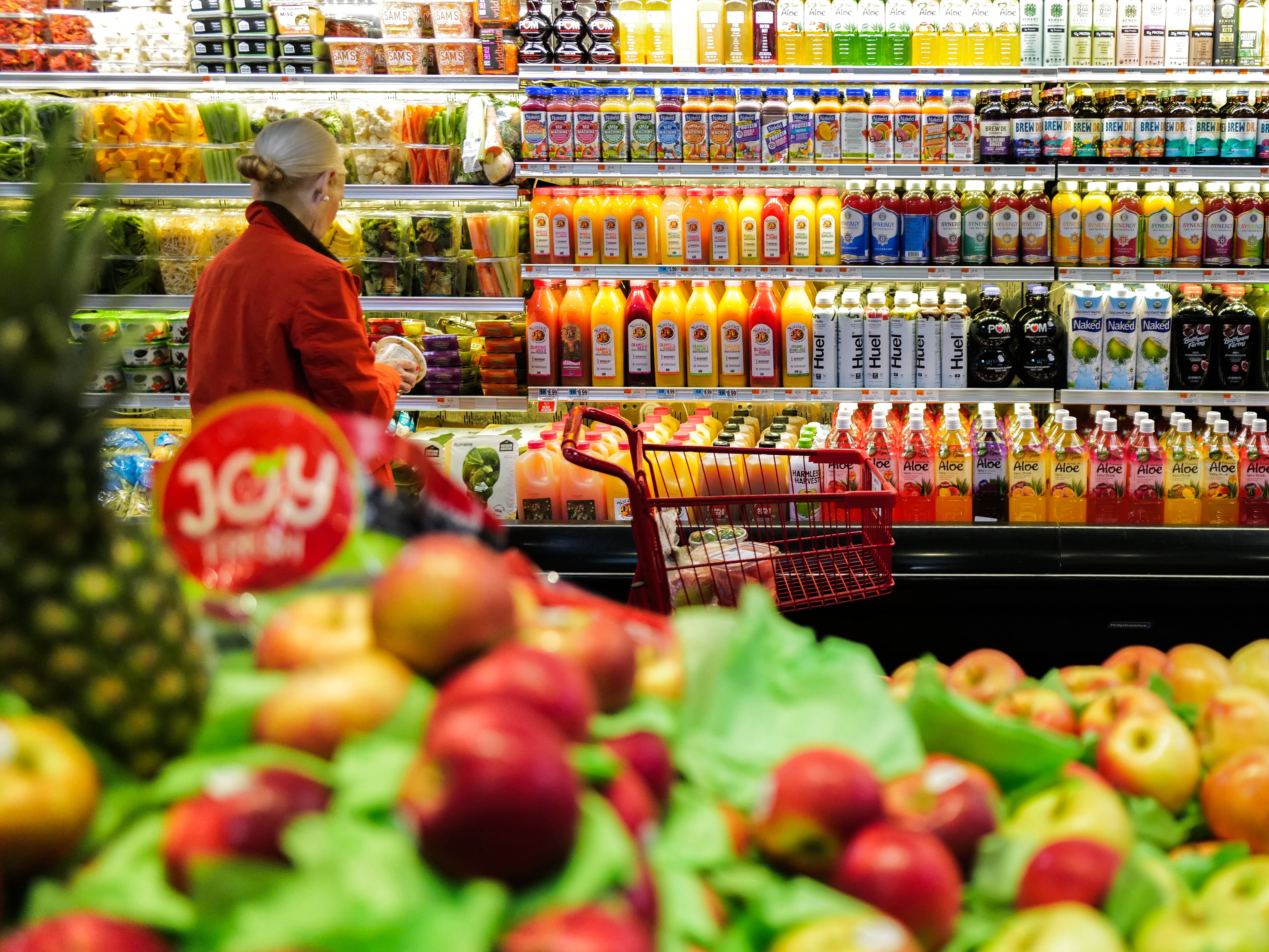 caption: A woman shops in a supermarket in New York on Jan. 27.