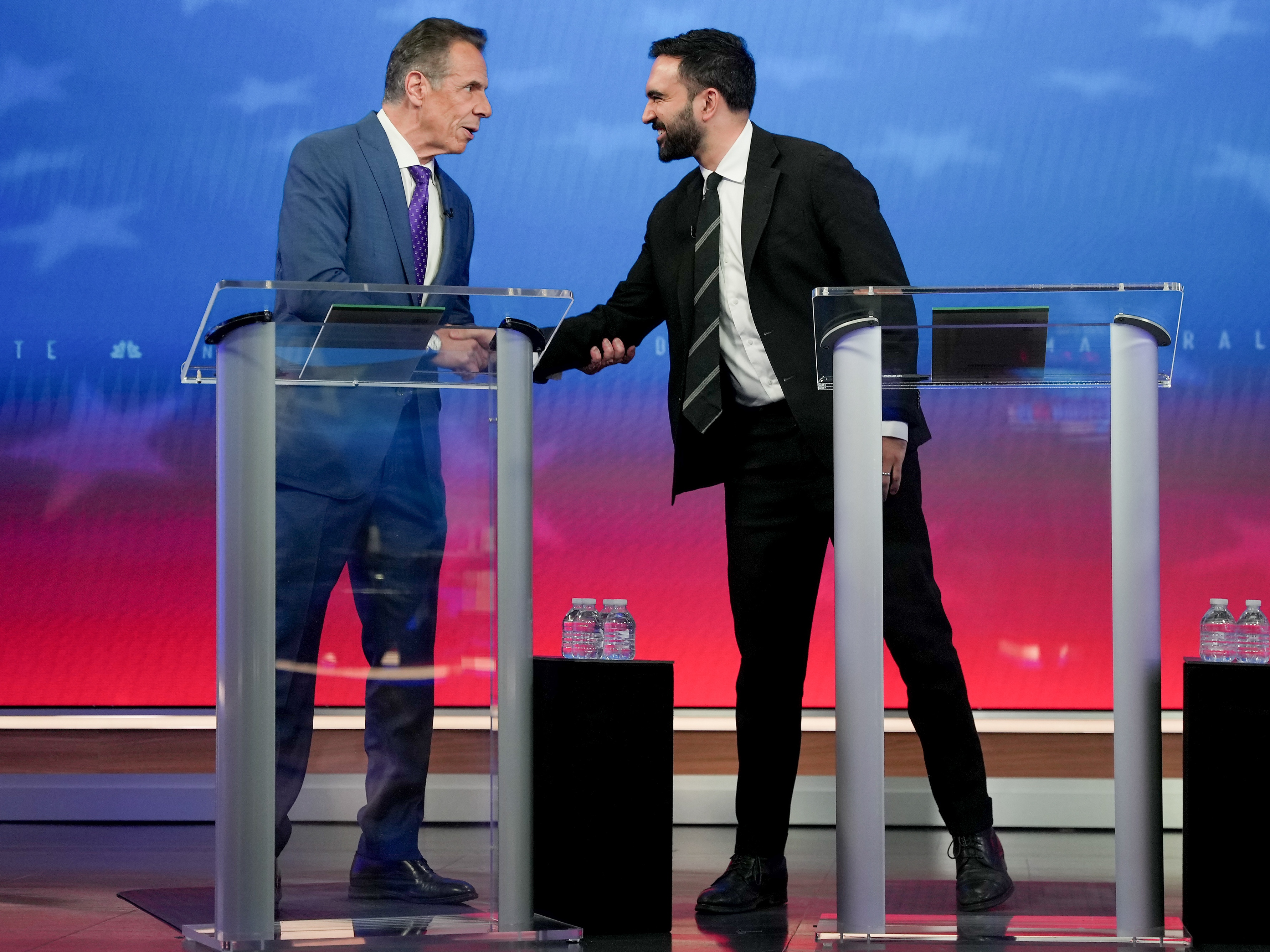 caption: Candidates Andrew Cuomo (left) and Zohran Mamdani shake hands during a mayoral debate in New York on Oct. 16.