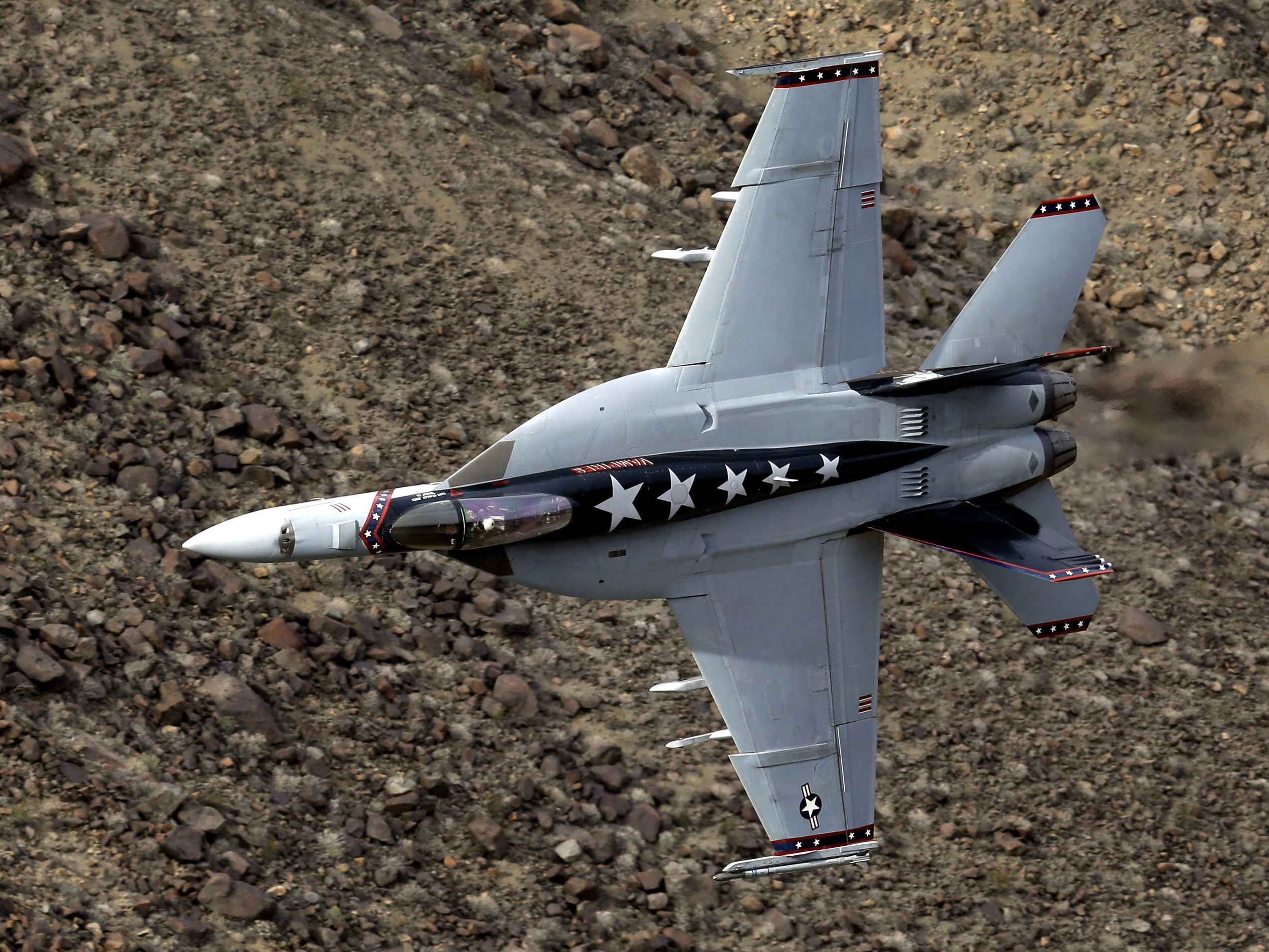 caption: A U.S. Navy F/A-18E Super Hornet jet flies in Death Valley National Park, Calif. The crash occurred near the viewing area where park visitors watch pilots fly through a chasm known as Star Wars Canyon.