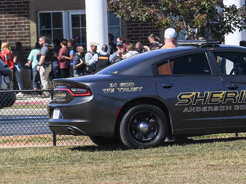 caption: In response to a false call about an active shooter, police and emergency workers descended on Robert Anderson Middle School in Anderson, South Carolina, on Oct. 5. Parents rushed to pick up their children, causing a traffic jam in front of the school.