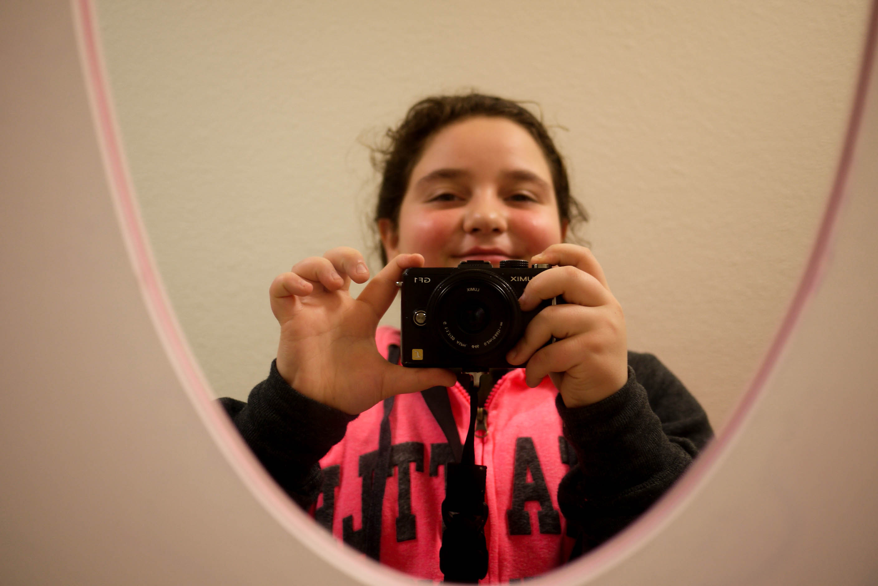 caption: Alaa, age 11, takes a selfie with a reporter's camera.