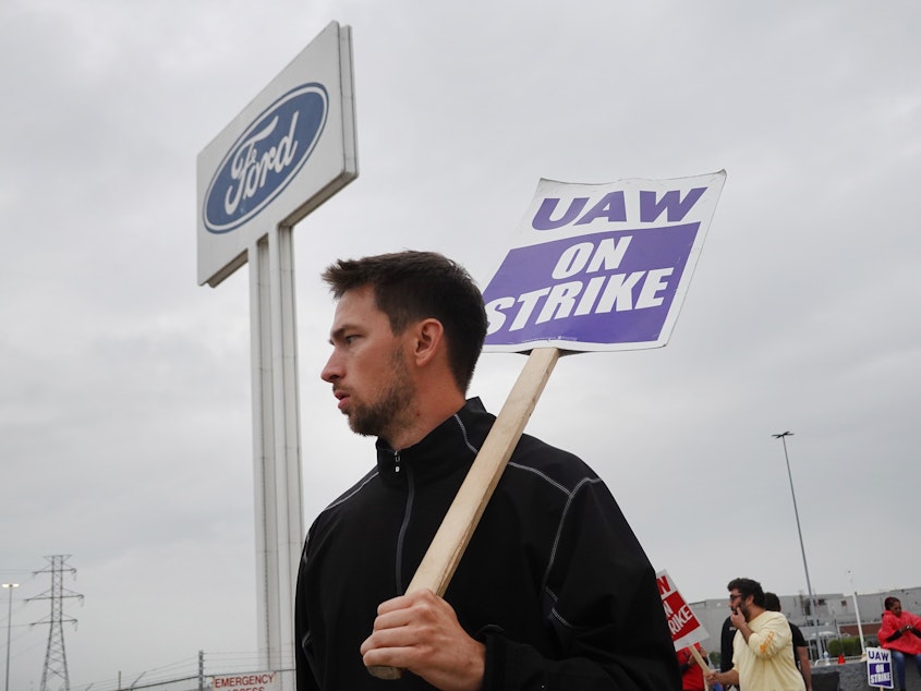 caption: UAW workers picket outside of Ford's Wayne Assembly Plant in Wayne, Mich., on Sept. 26, 2023. The union and Ford reached a tentative agreement on Wednesday, in a major potential development in the ongoing strike against the Big Three automakers.