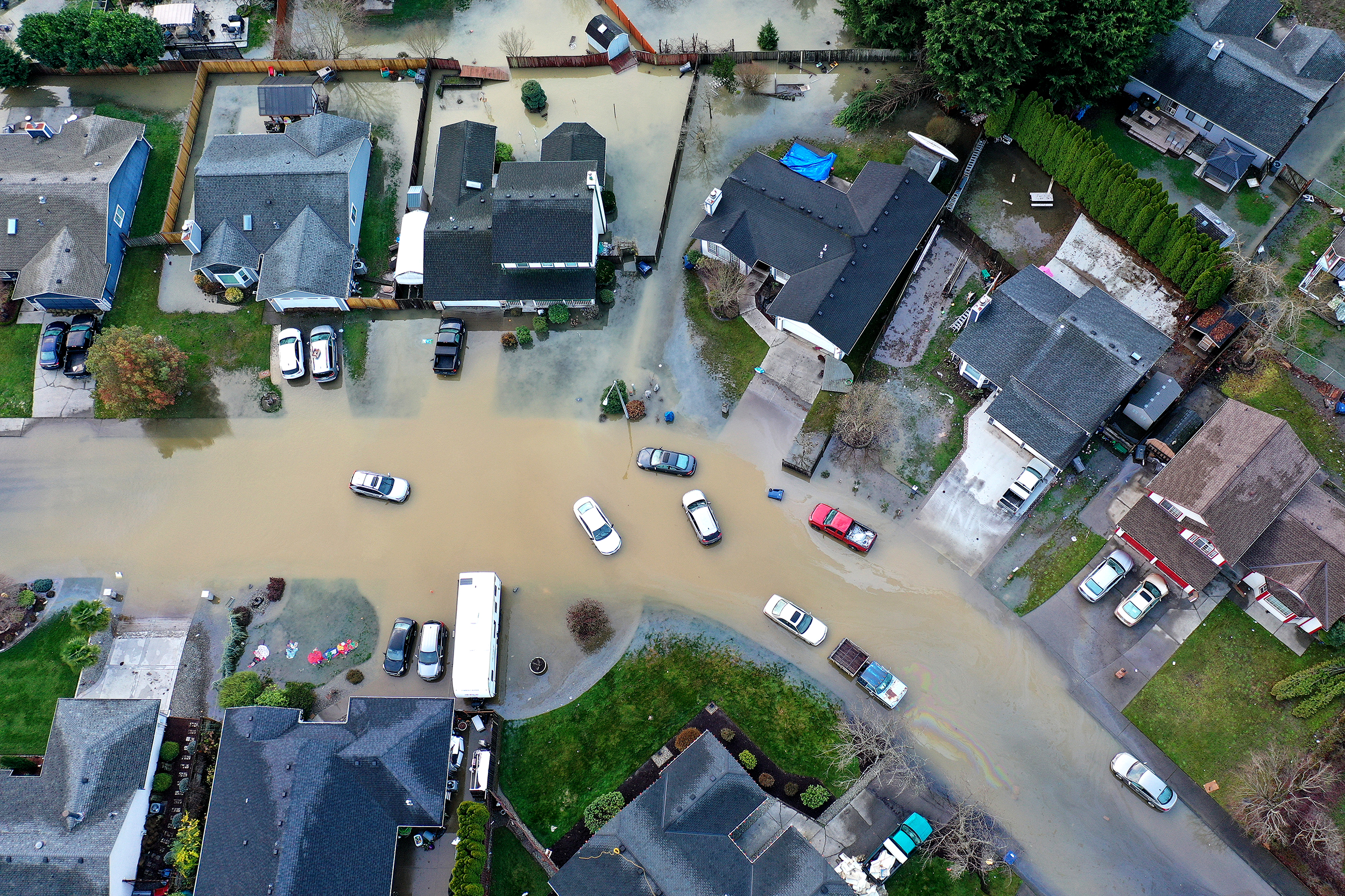 caption: Flooding from the White River is shown surrounding homes near Butte Avenue on Wednesday, December 17, 2025, in Pacific. We don't have numbers yet on how many Washington homes and businesses have experienced flooding. Emergency officials say it's too early to even guess until flood waters recede.