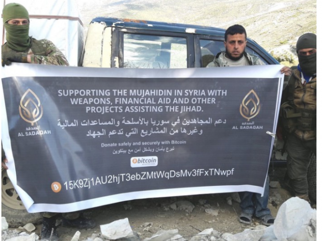 caption: In an image released by the Department of Justice, a group solicits funds for weapons by asking for bitcoin. The Trump administration says al-Qaida and affiliated groups have used such donations to fund terrorism.