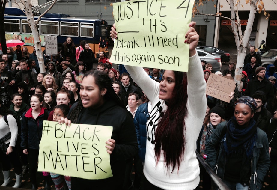 caption: Demonstrators at a Seattle march in response to Ferguson