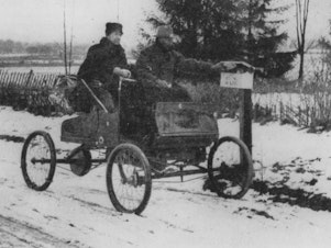 caption: A rural mail carrier in 1905 trying out new transportation technology.